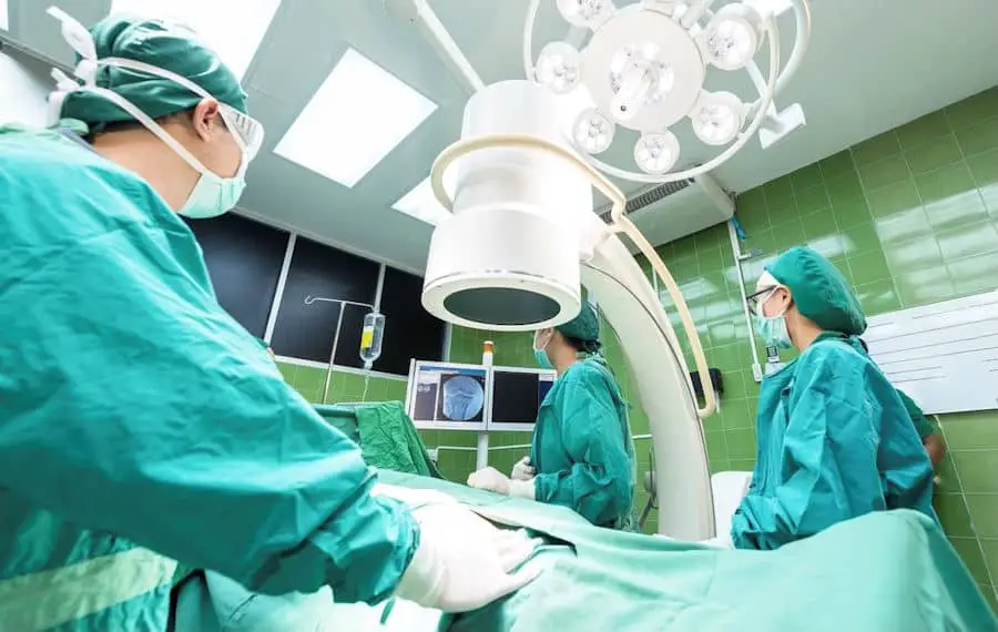 view of an operating room with surgeons and nurses preparing a patient