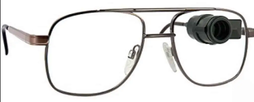 pair of eyeglasses with a bioptic telescope mounted high on one lens