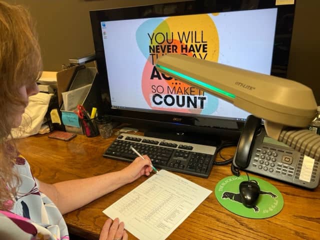 image of computer work station with adjustable task lighting and large screen monitor.