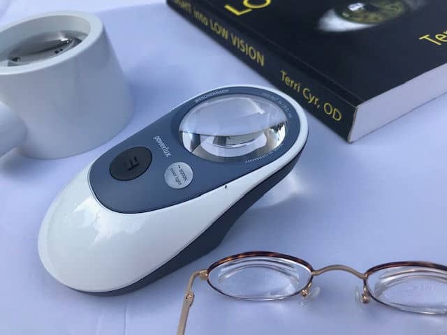image of low vision magnifying devices used to train the visually impaired, glasses, stand magnifier with handle, and 20x magnifier