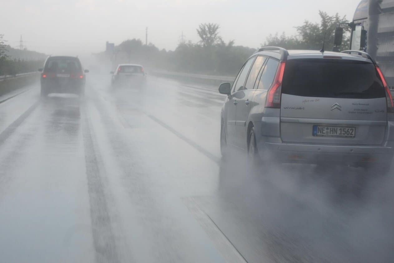 drivers view of a road with traffic on a rainy day